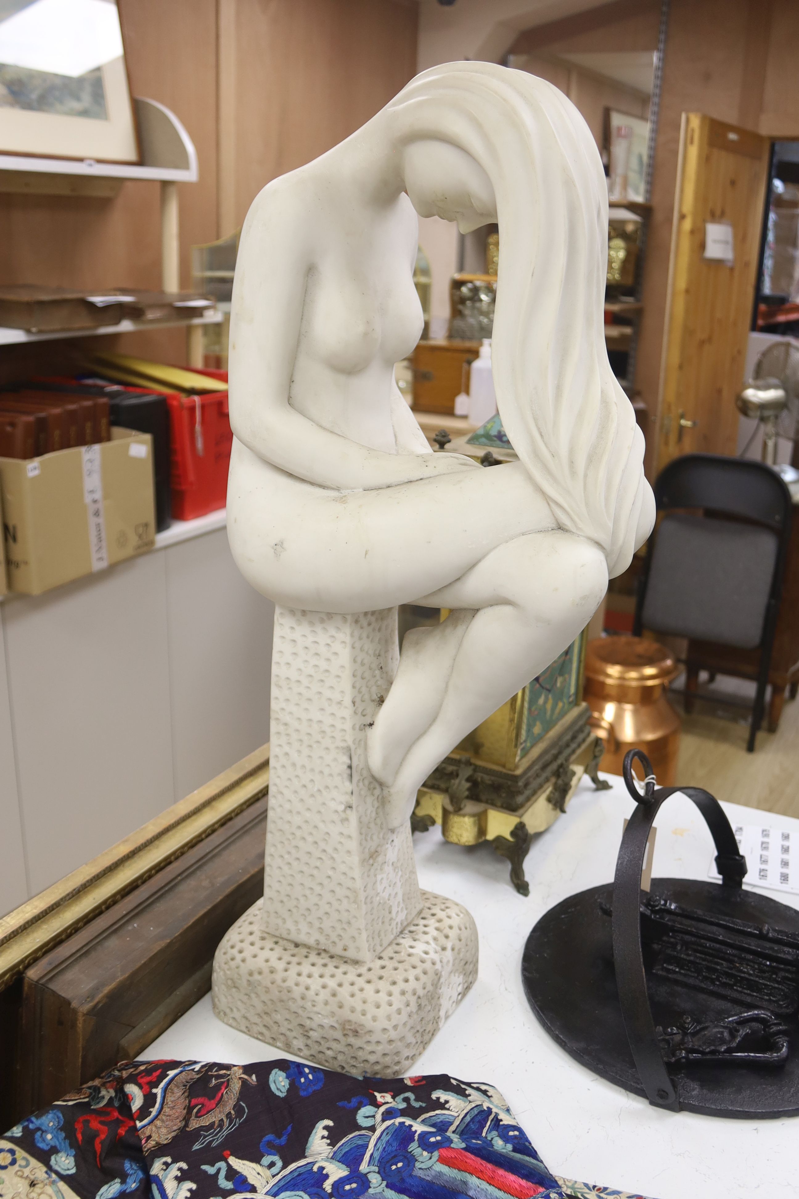 A faux marble figure of a seated nude, on plinth, height 81cm